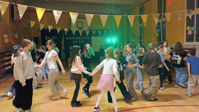 dzieci tańczą w sali gimnastycznej przystrojonej karnawałowo